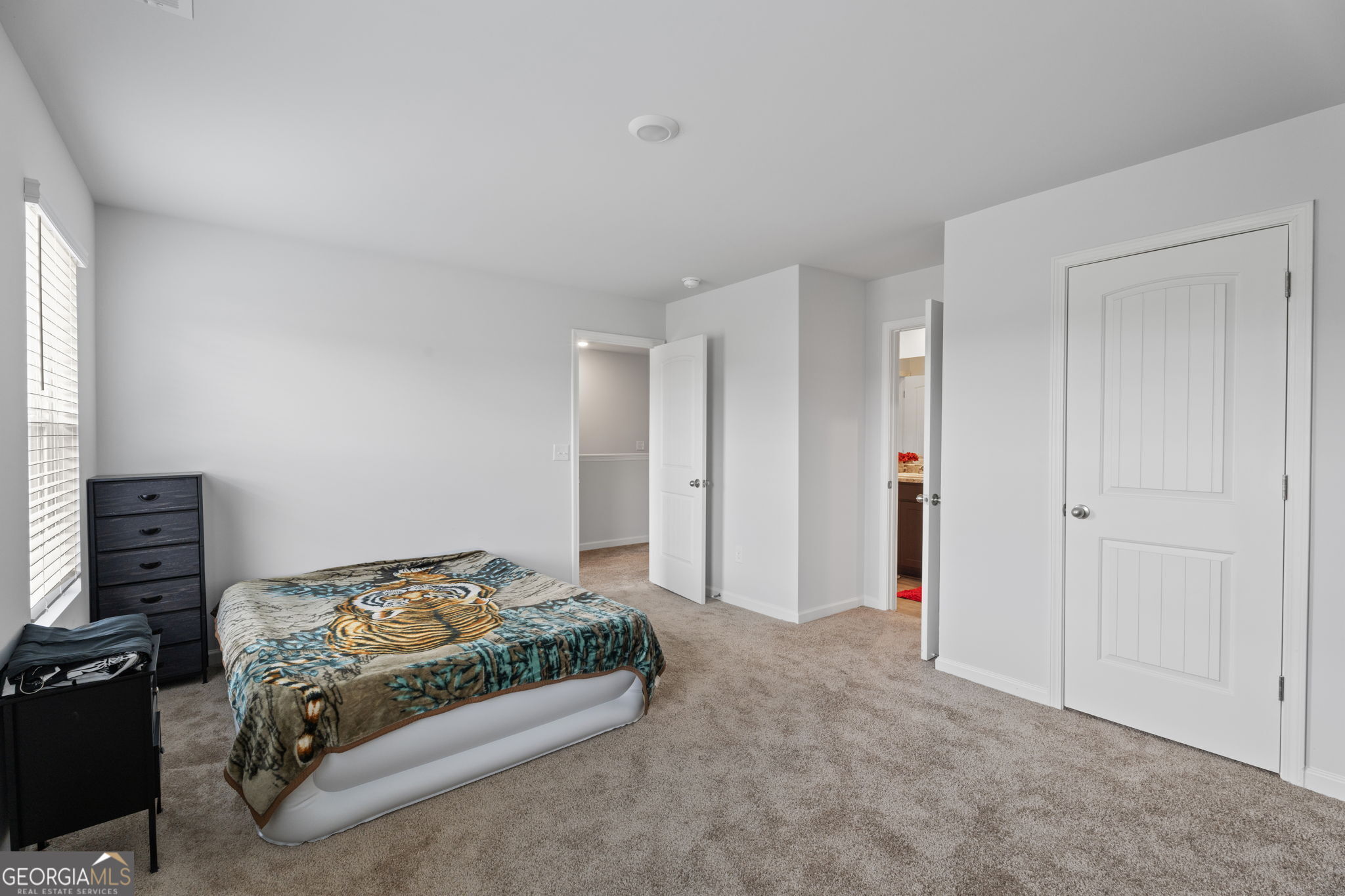 321 Kirt's Ridge Jackson, GA 30233 - Photo 49 of 57 a spacious bedroom with a bed and a tv