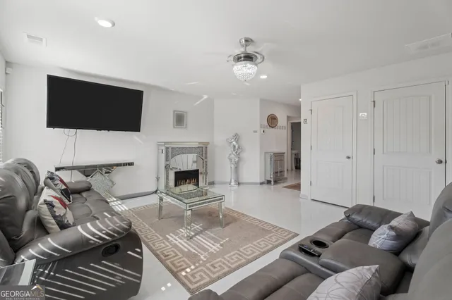 a living room with furniture a fireplace and a flat screen tv