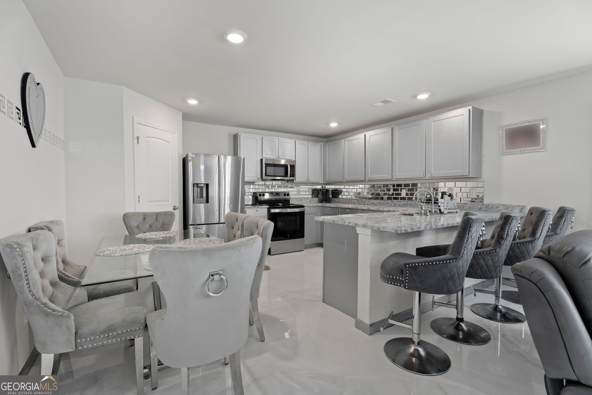 321 Kirt's Ridge Jackson, GA 30233 - Photo 7 of 57 a kitchen with kitchen island a appliances dining table and chairs