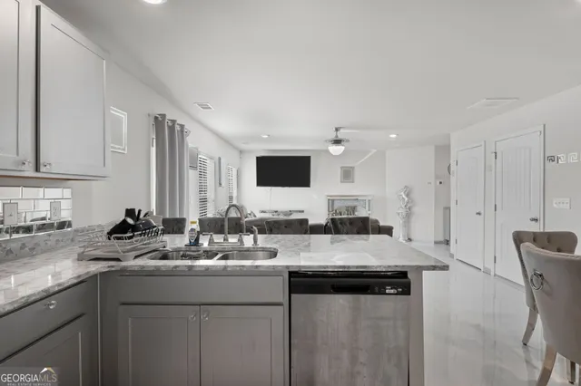 a kitchen with sink cabinets and stainless steel appliances