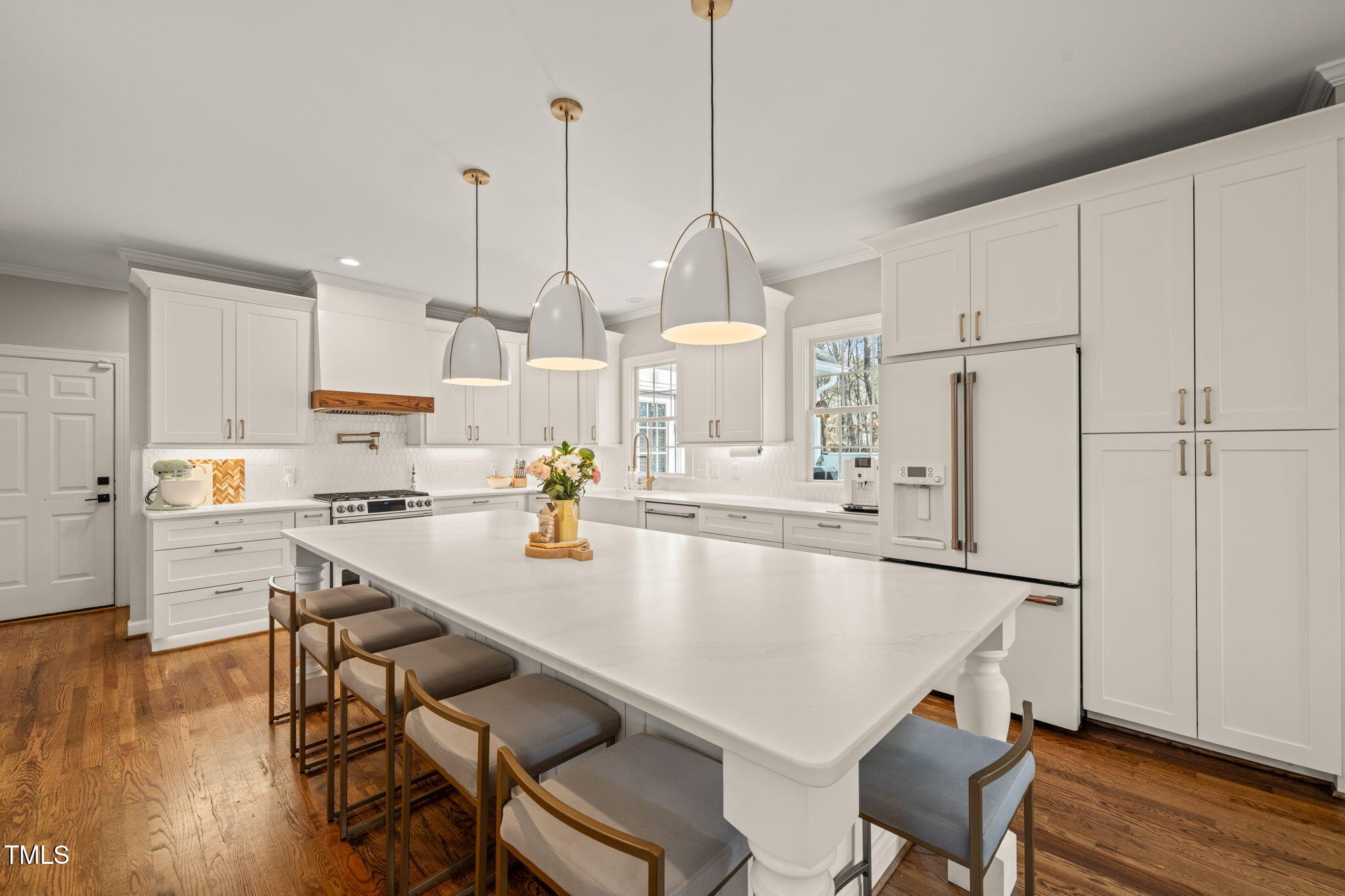 5032 Big Creek Road Raleigh, NC 27613 - Photo 12 of 46 a kitchen with stainless steel appliances a stove a sink a center island and wooden floor