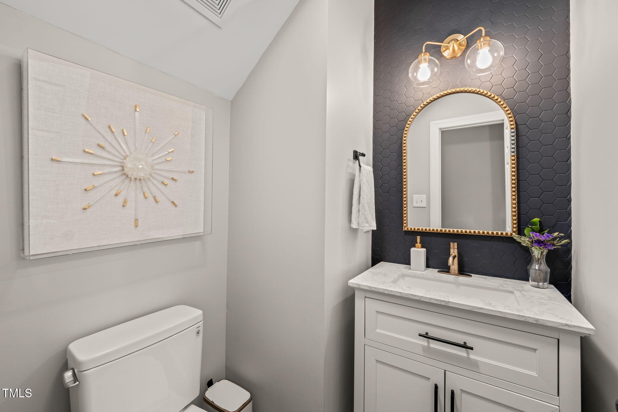 5032 Big Creek Road Raleigh, NC 27613 - Photo 15 of 46 a bathroom with a toilet sink and mirror