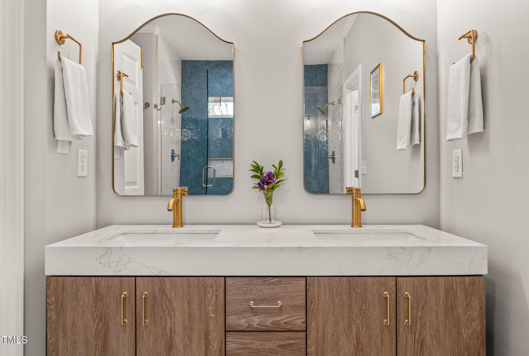 5032 Big Creek Road Raleigh, NC 27613 - Photo 21 of 46 a bathroom with a sink and a mirror