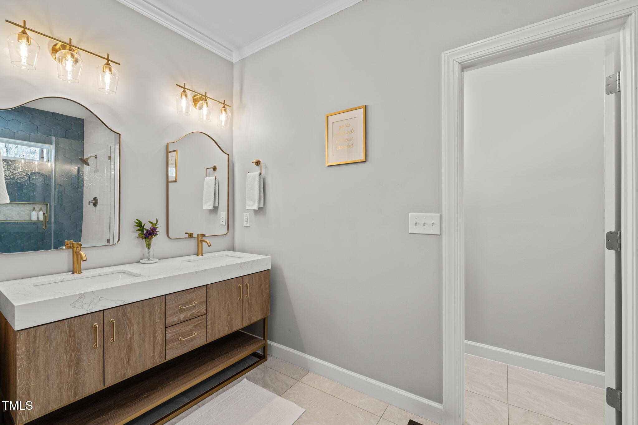 5032 Big Creek Road Raleigh, NC 27613 - Photo 23 of 46 a bathroom with a double vanity sink and a mirror