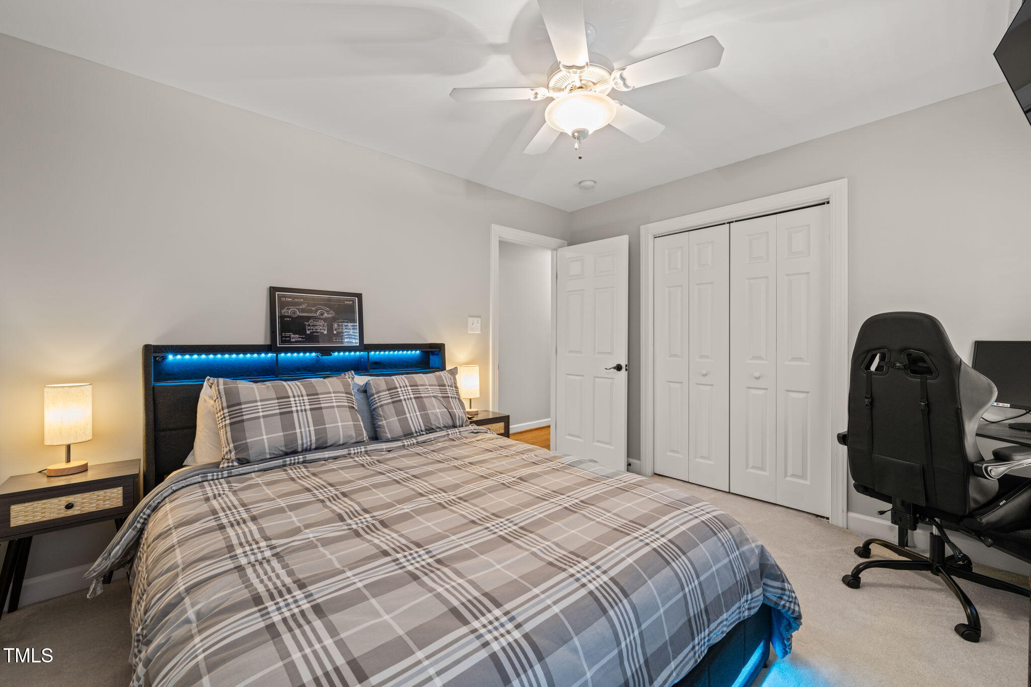 5032 Big Creek Road Raleigh, NC 27613 - Photo 31 of 46 a bedroom with a bed and a chandelier