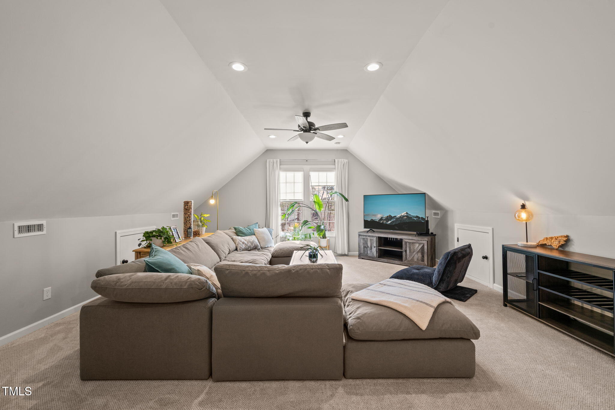 5032 Big Creek Road Raleigh, NC 27613 - Photo 35 of 46 a living room with furniture a fireplace and a flat screen tv