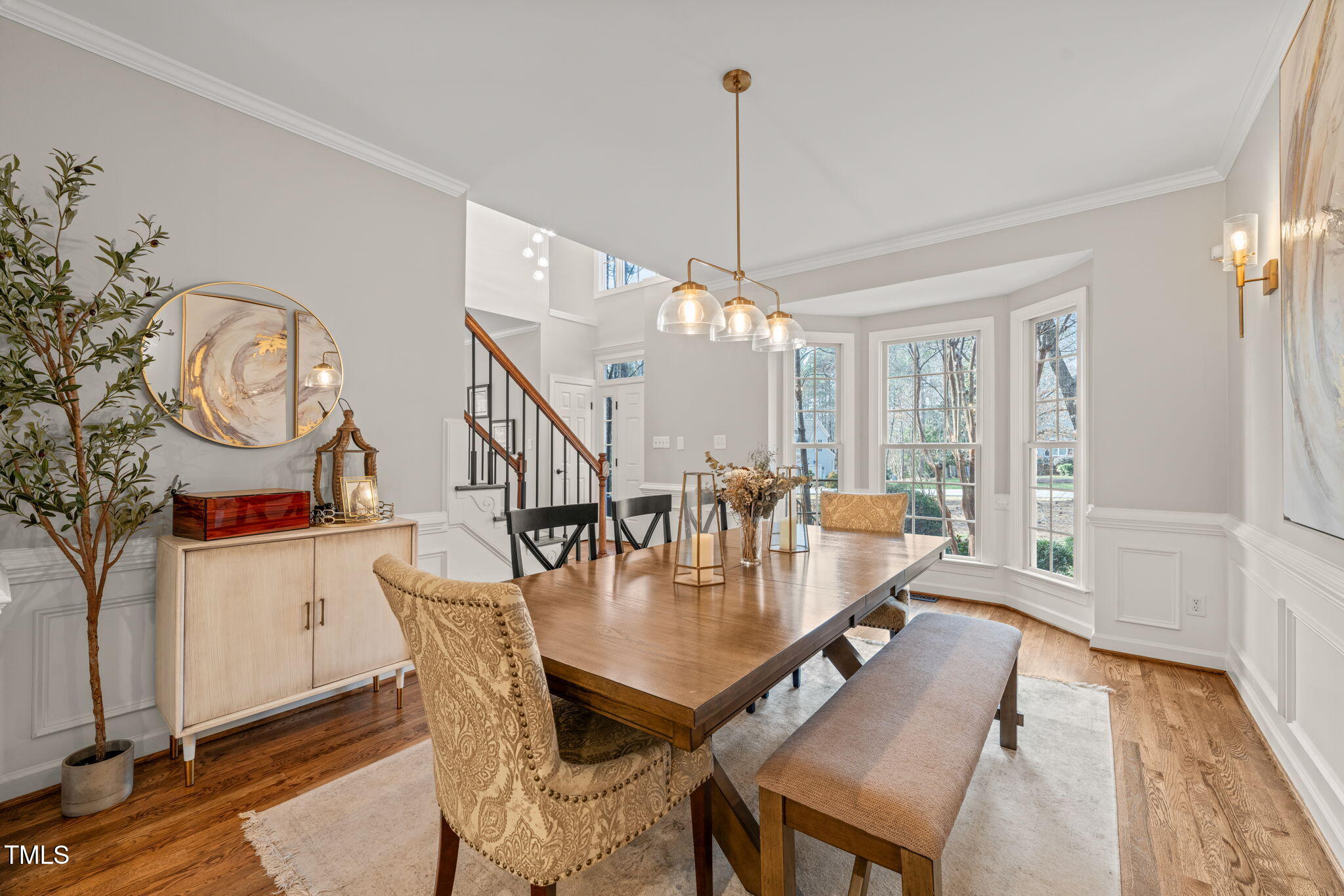 5032 Big Creek Road Raleigh, NC 27613 - Photo 4 of 46 a dining room with furniture a chandelier and wooden floor