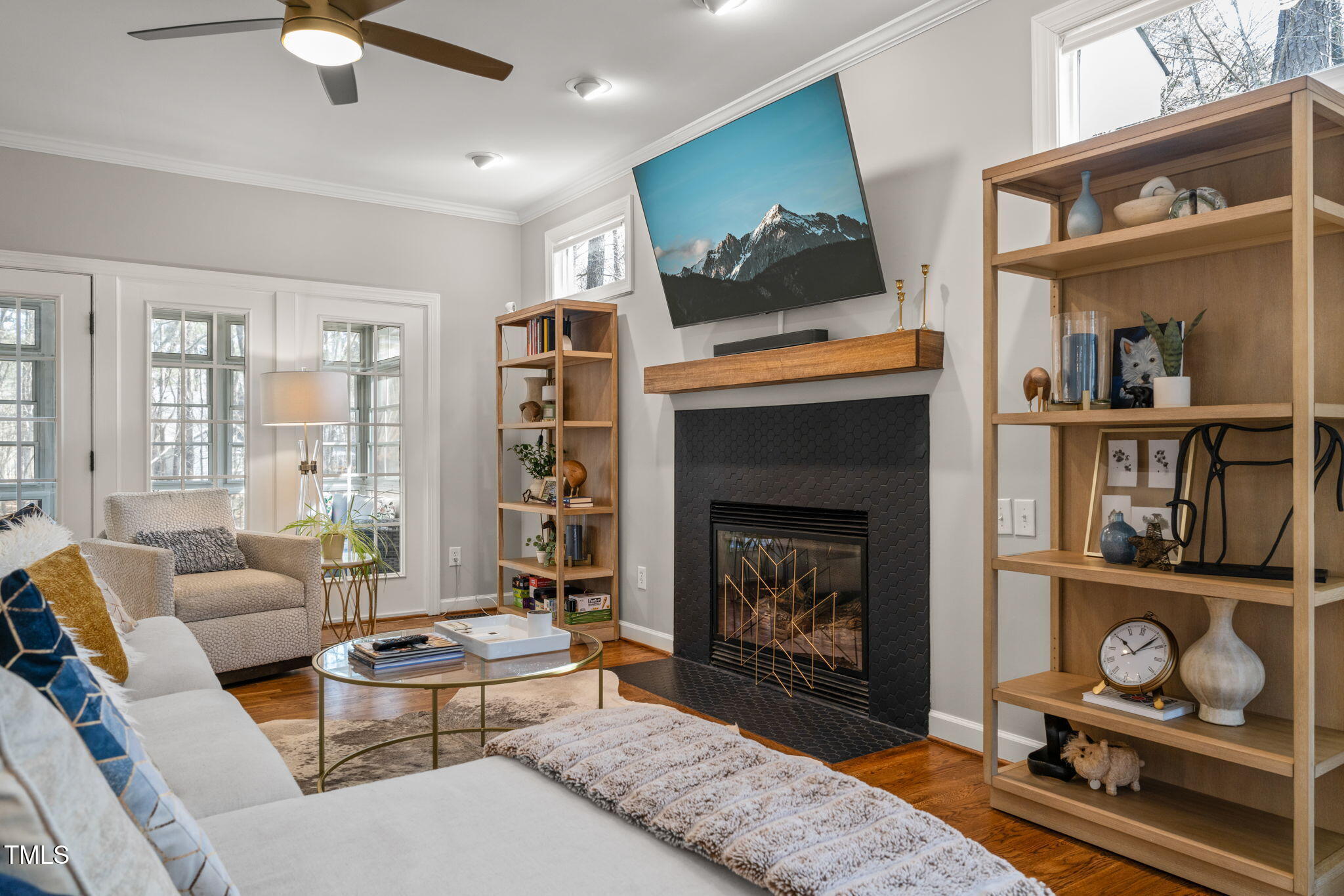 5032 Big Creek Road Raleigh, NC 27613 - Photo 6 of 46 a living room with furniture a flat screen tv and a fireplace