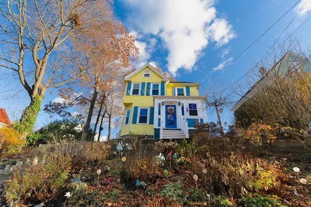 a front view of a house with a yard and fountain in middle