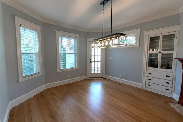 a living room with wooden floor and a window