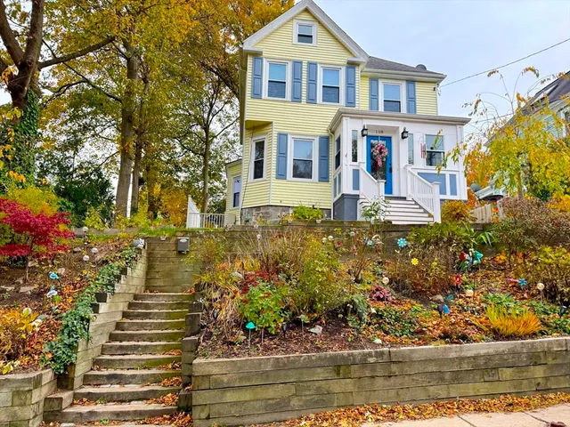 a front view of a house with a garden