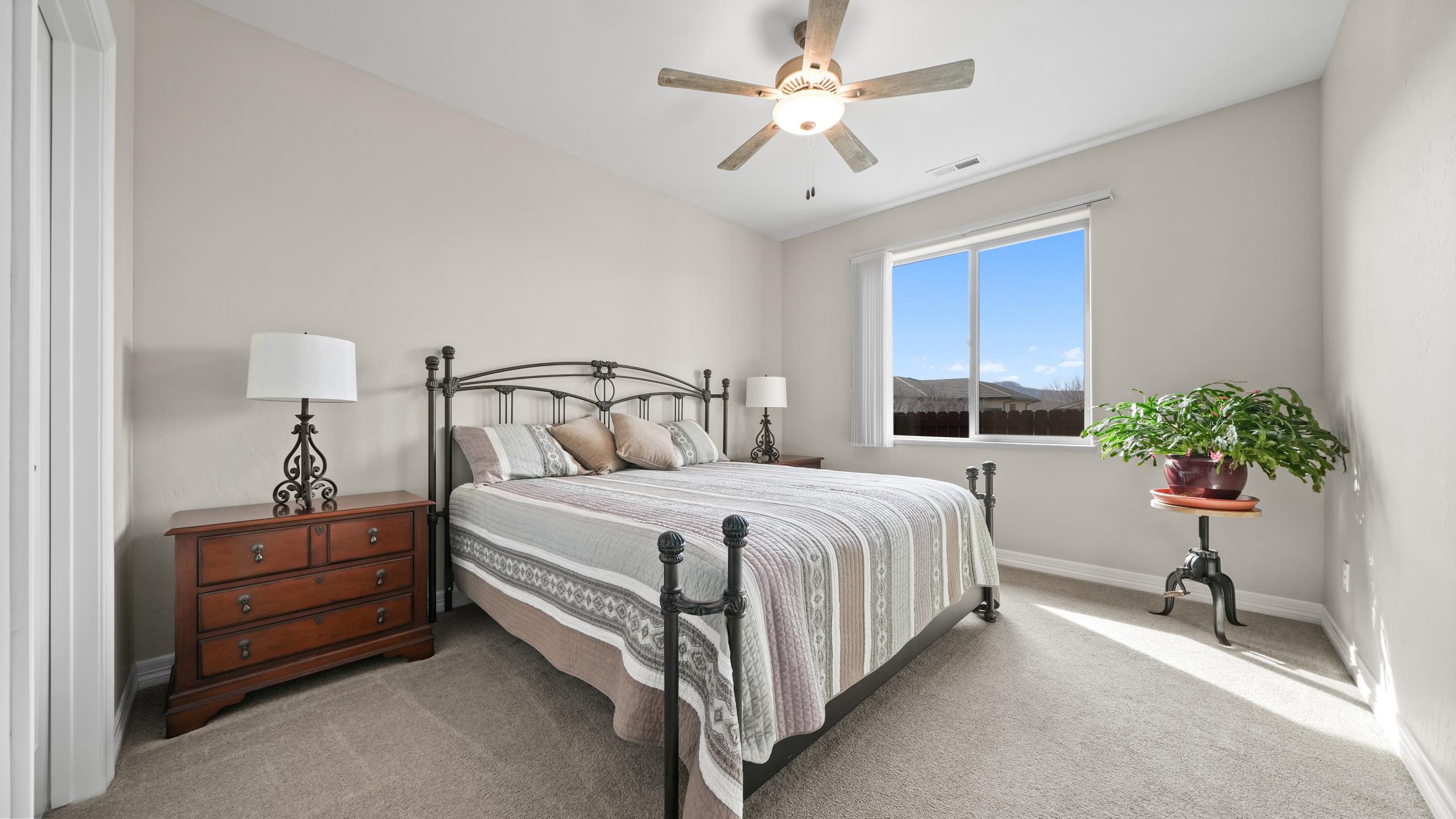 1295 Eagle Way Fruita, CO 81521 - Photo 16 of 36 a bedroom with a bed and a potted plant