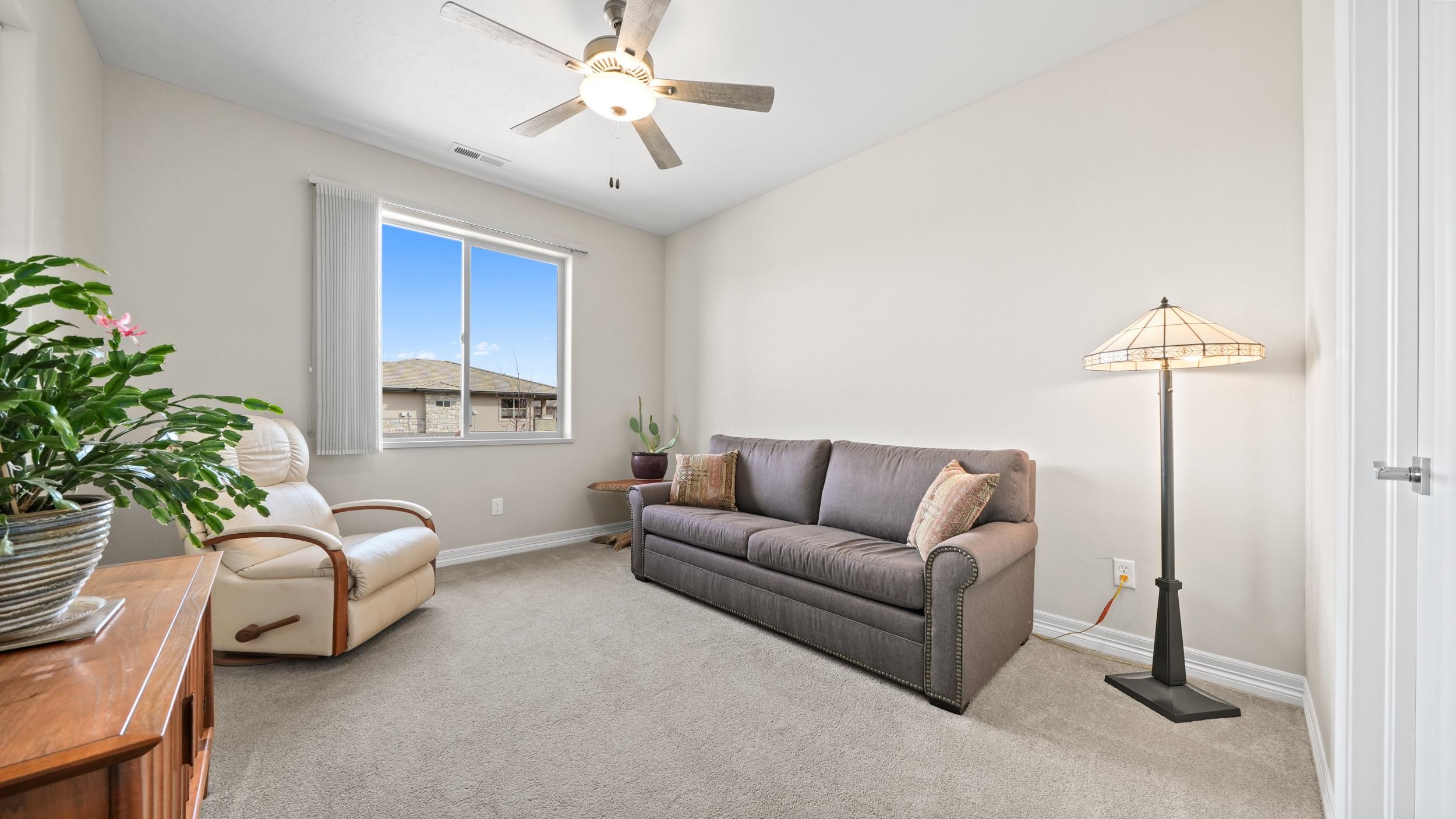 1295 Eagle Way Fruita, CO 81521 - Photo 18 of 36 a living room with furniture and a window