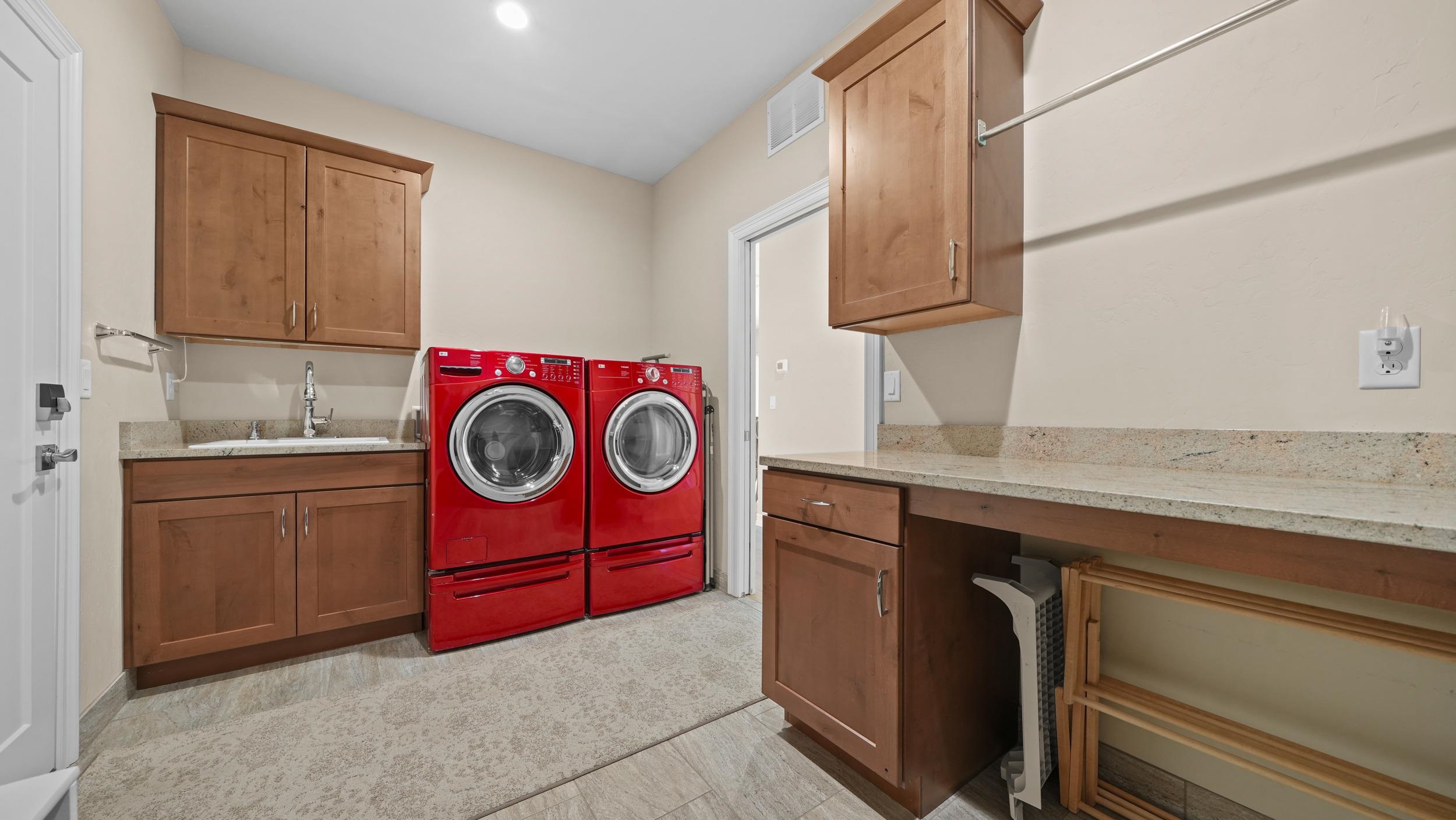 1295 Eagle Way Fruita, CO 81521 - Photo 20 of 36 a utility room with fridge and wooden cabinets