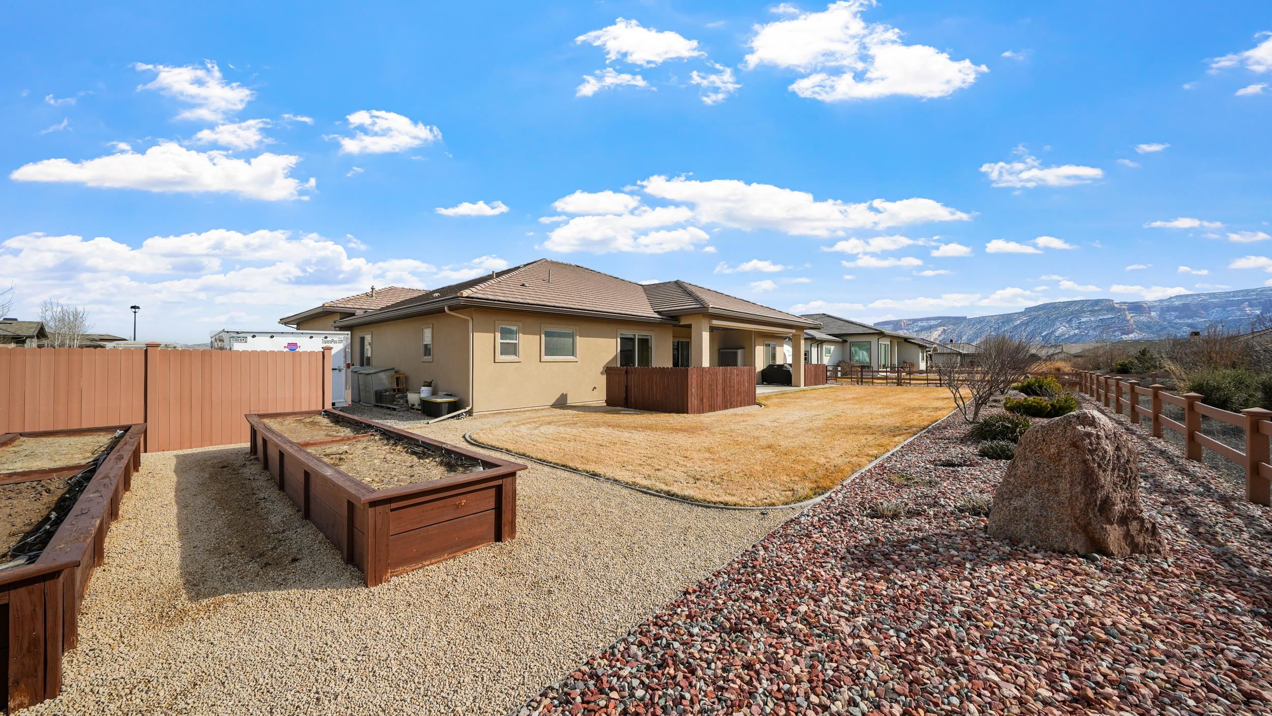 1295 Eagle Way Fruita, CO 81521 - Photo 26 of 36 a front view of a house with a yard