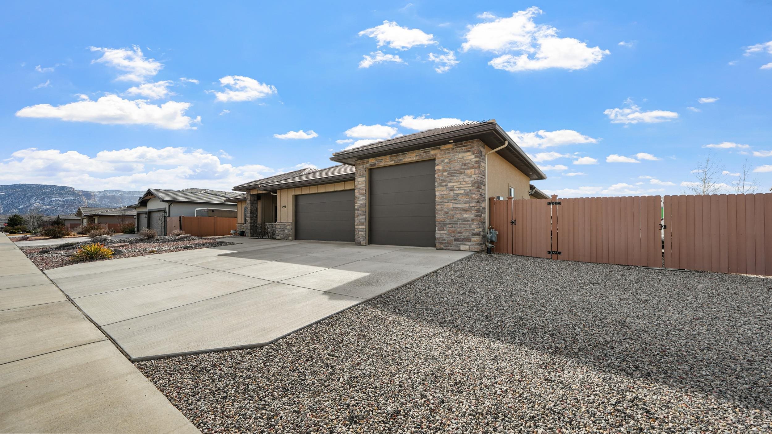 1295 Eagle Way Fruita, CO 81521 - Photo 35 of 36 a view of a house with a yard and garage
