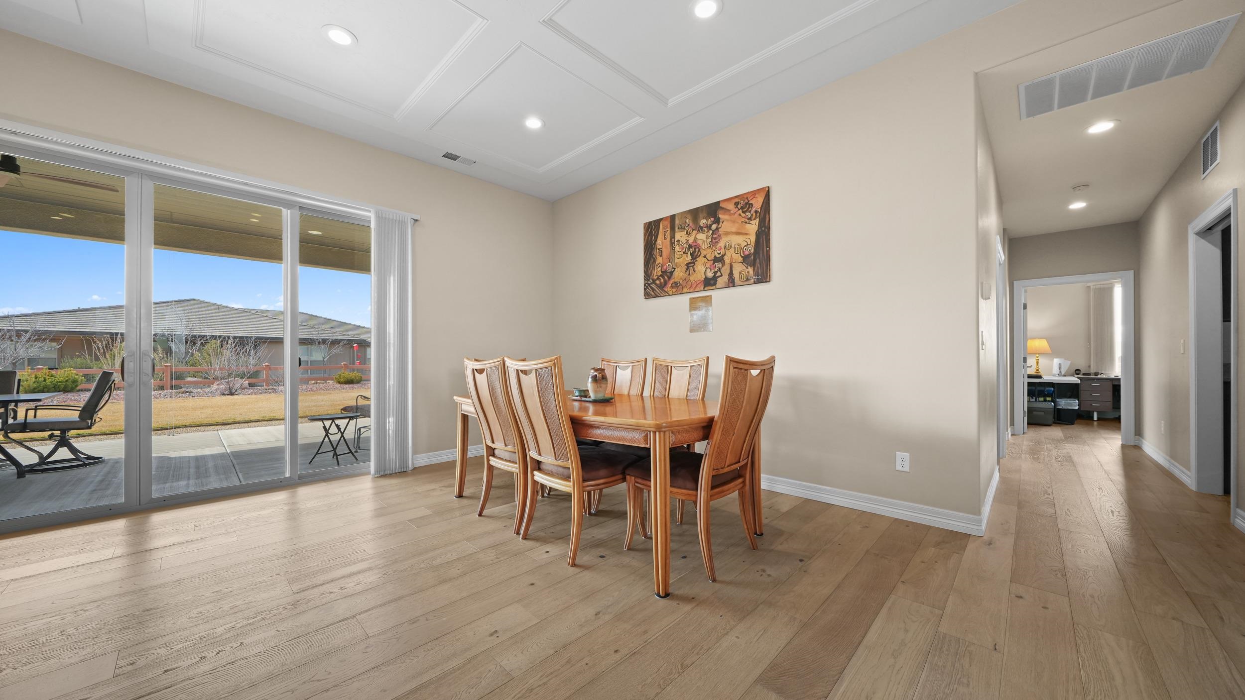 1295 Eagle Way Fruita, CO 81521 - Photo 7 of 36 a view of a dining room with furniture and wooden floor