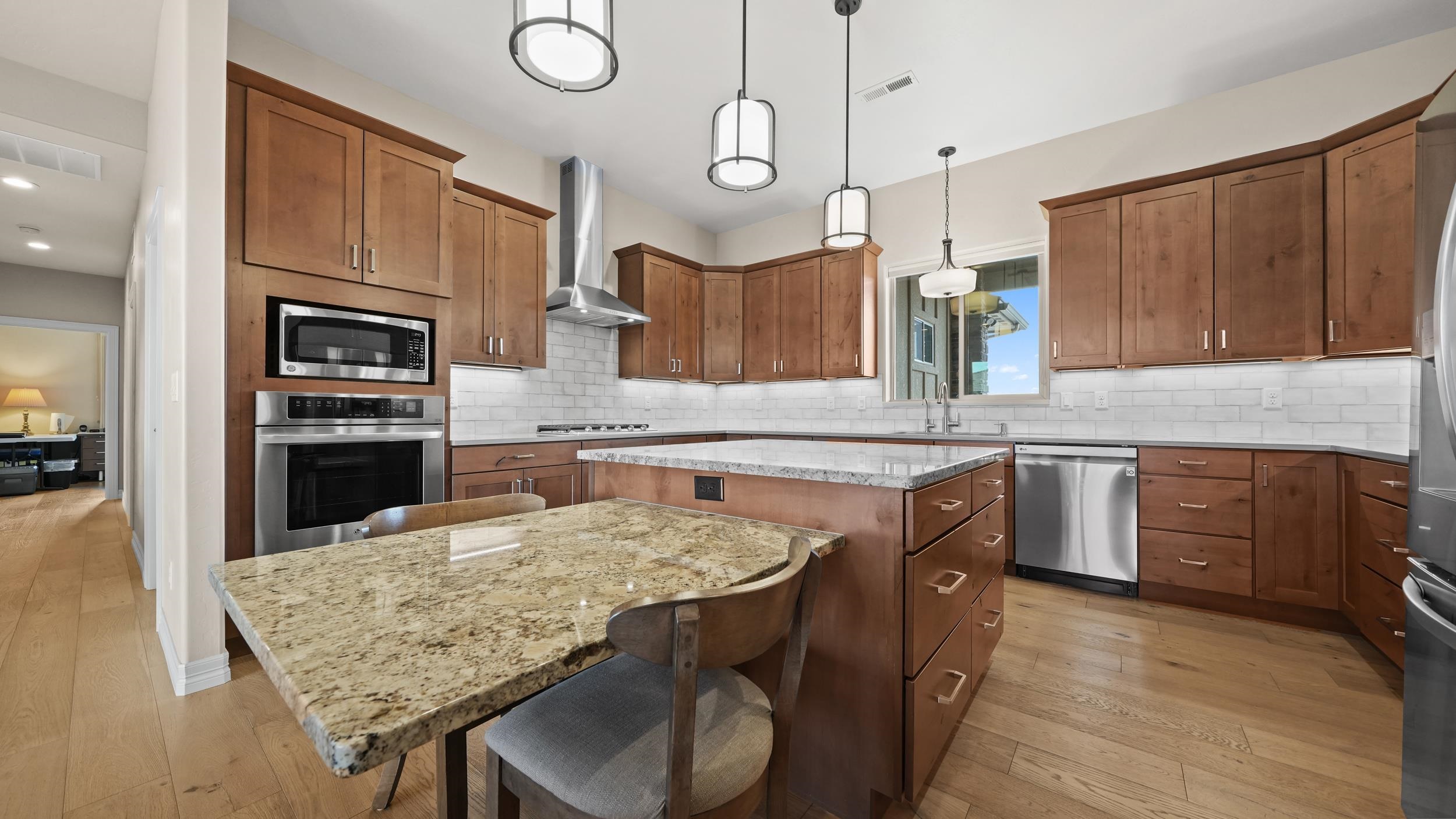 1295 Eagle Way Fruita, CO 81521 - Photo 8 of 36 a kitchen with granite countertop a stove a sink and a refrigerator