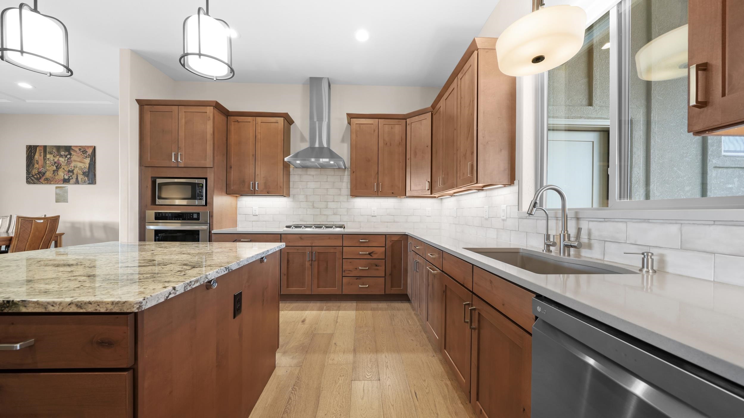 1295 Eagle Way Fruita, CO 81521 - Photo 10 of 36 a kitchen with stainless steel appliances granite countertop a sink refrigerator and cabinets