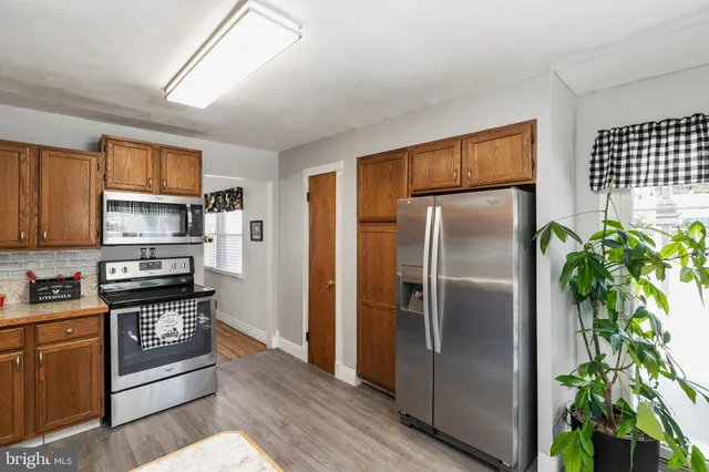 a kitchen with stainless steel appliances granite countertop a refrigerator and a sink