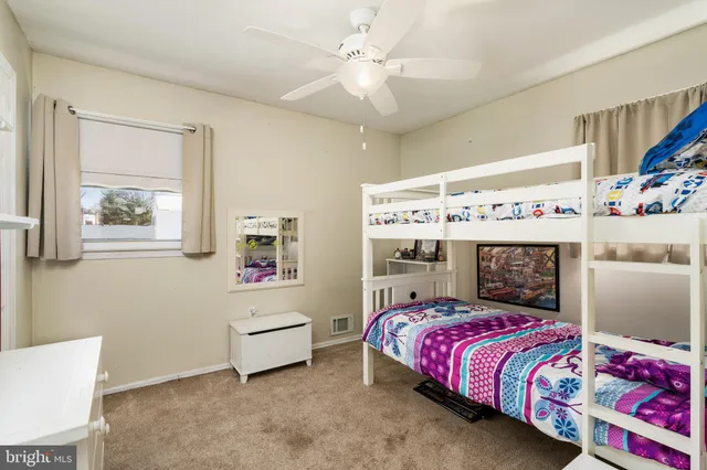 a bathroom with a sink a toilet and a window