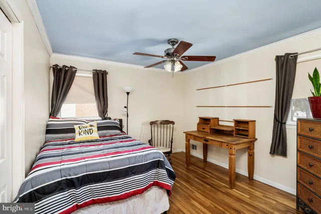 a bedroom with a bed and a potted plant