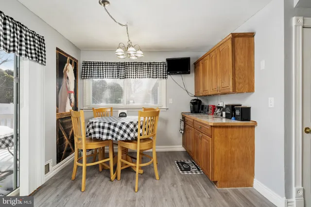 a kitchen with granite countertop a sink cabinets and stainless steel appliances