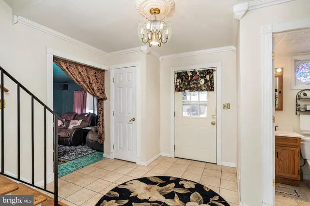 a bedroom with furniture entryway and wooden floor