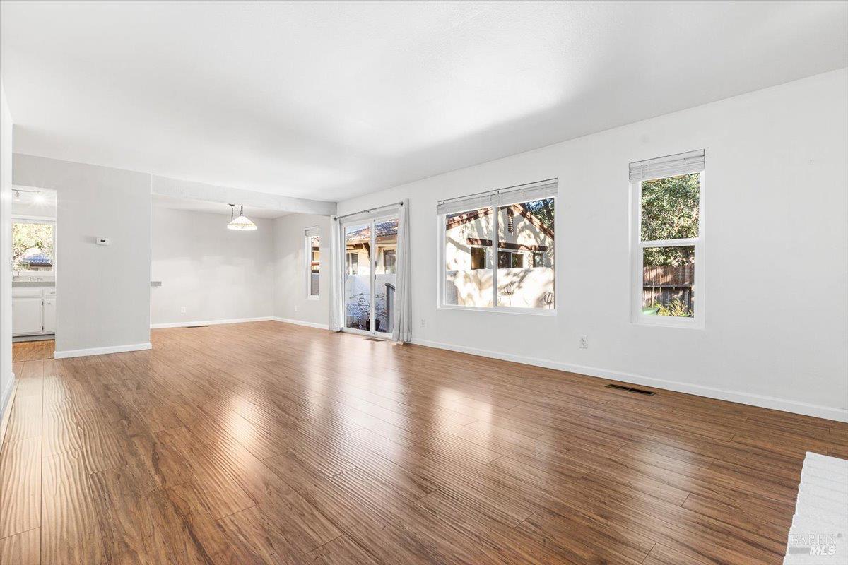 802 Adobe Drive Santa Rosa, CA 95404 - Photo 13 of 32 an empty room with wooden floor and windows