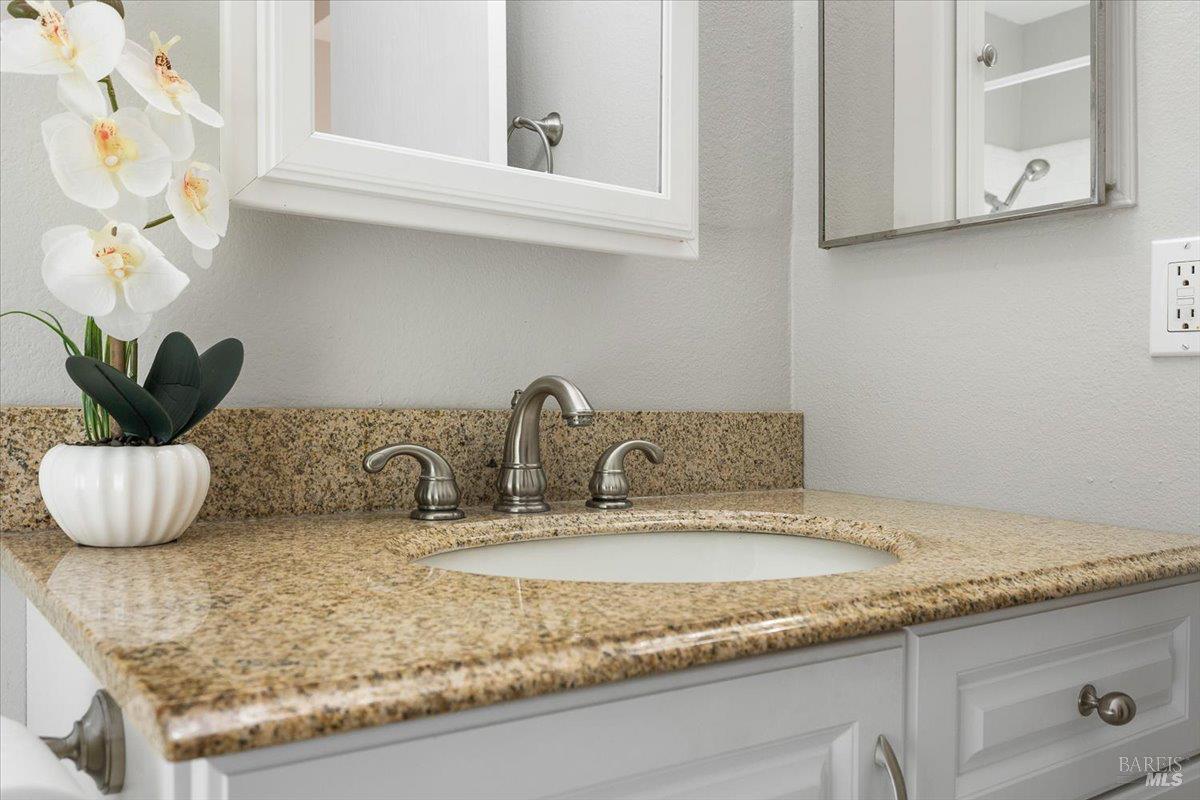 802 Adobe Drive Santa Rosa, CA 95404 - Photo 19 of 32 a kitchen with granite countertop a sink and white cabinets