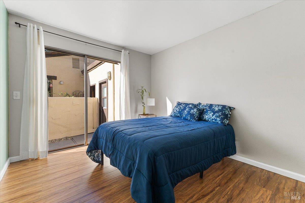 802 Adobe Drive Santa Rosa, CA 95404 - Photo 20 of 32 a bedroom with a bed and wooden floor
