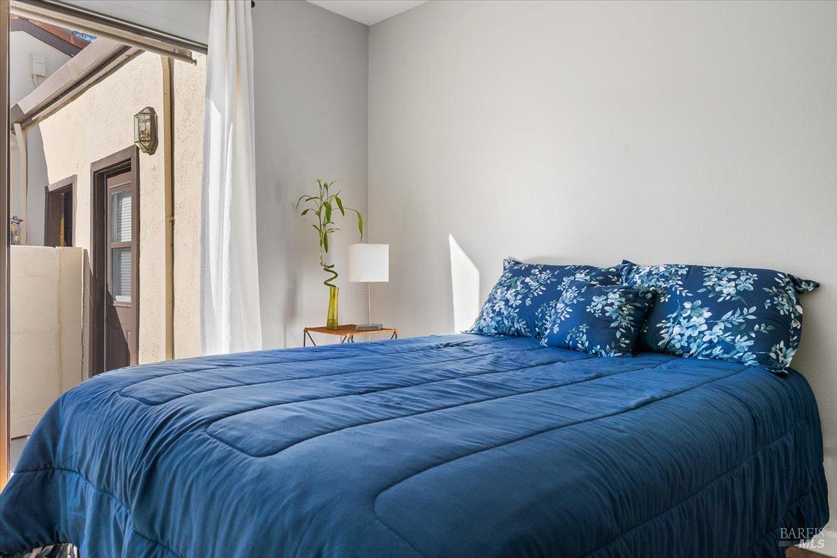 802 Adobe Drive Santa Rosa, CA 95404 - Photo 22 of 32 a bedroom with a bed lamp and a window