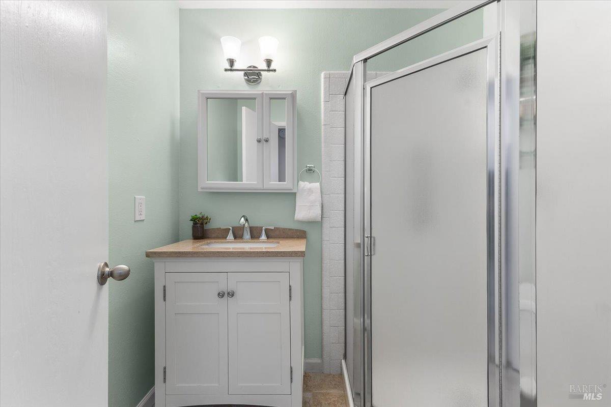 802 Adobe Drive Santa Rosa, CA 95404 - Photo 23 of 32 a bathroom with a shower sink and mirror