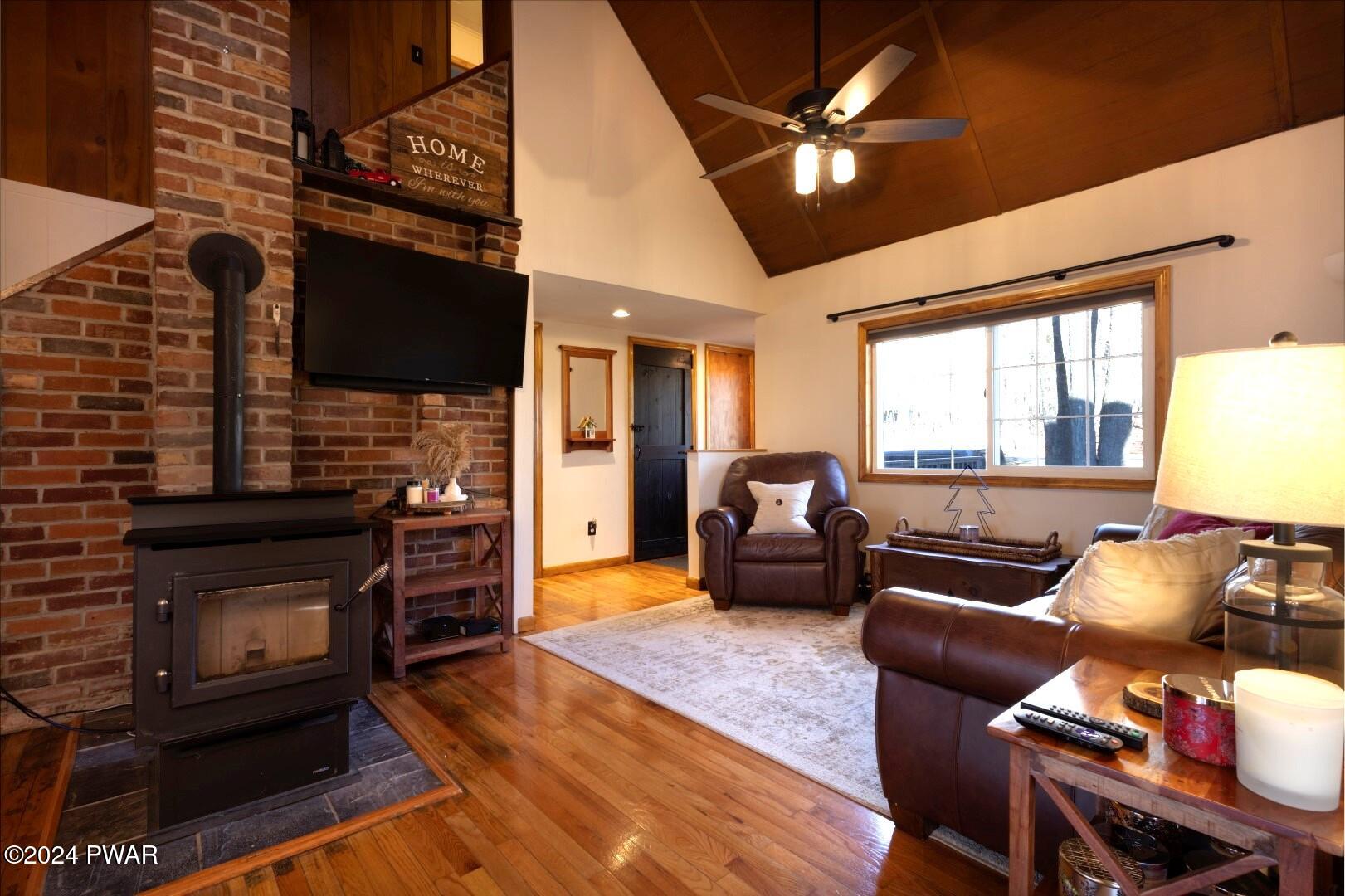 137 Stonehenge Road Milford, PA 18337 - Photo 4 of 30 a living room with furniture a flat screen tv and a fireplace