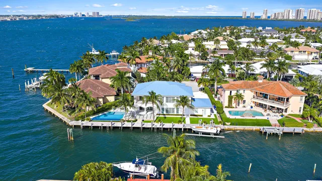 an aerial view of a house with a swimming pool patio and outdoor seating