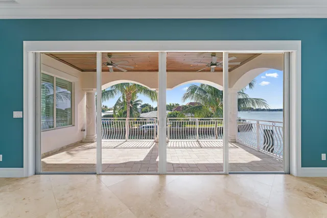 an aerial view of a city with lots of residential buildings ocean and mountain view in back
