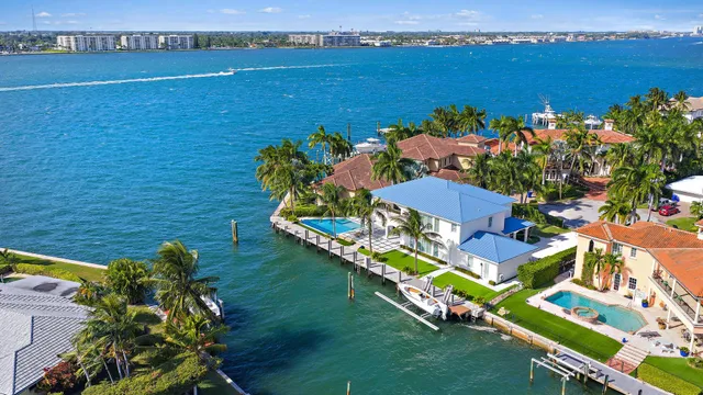 a living room with furniture large windows and a flat screen tv