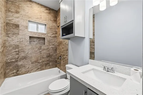 a bathroom with a sink a toilet and bathtub