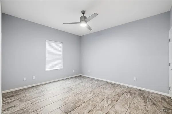 an empty room with a empty space and a ceiling fan