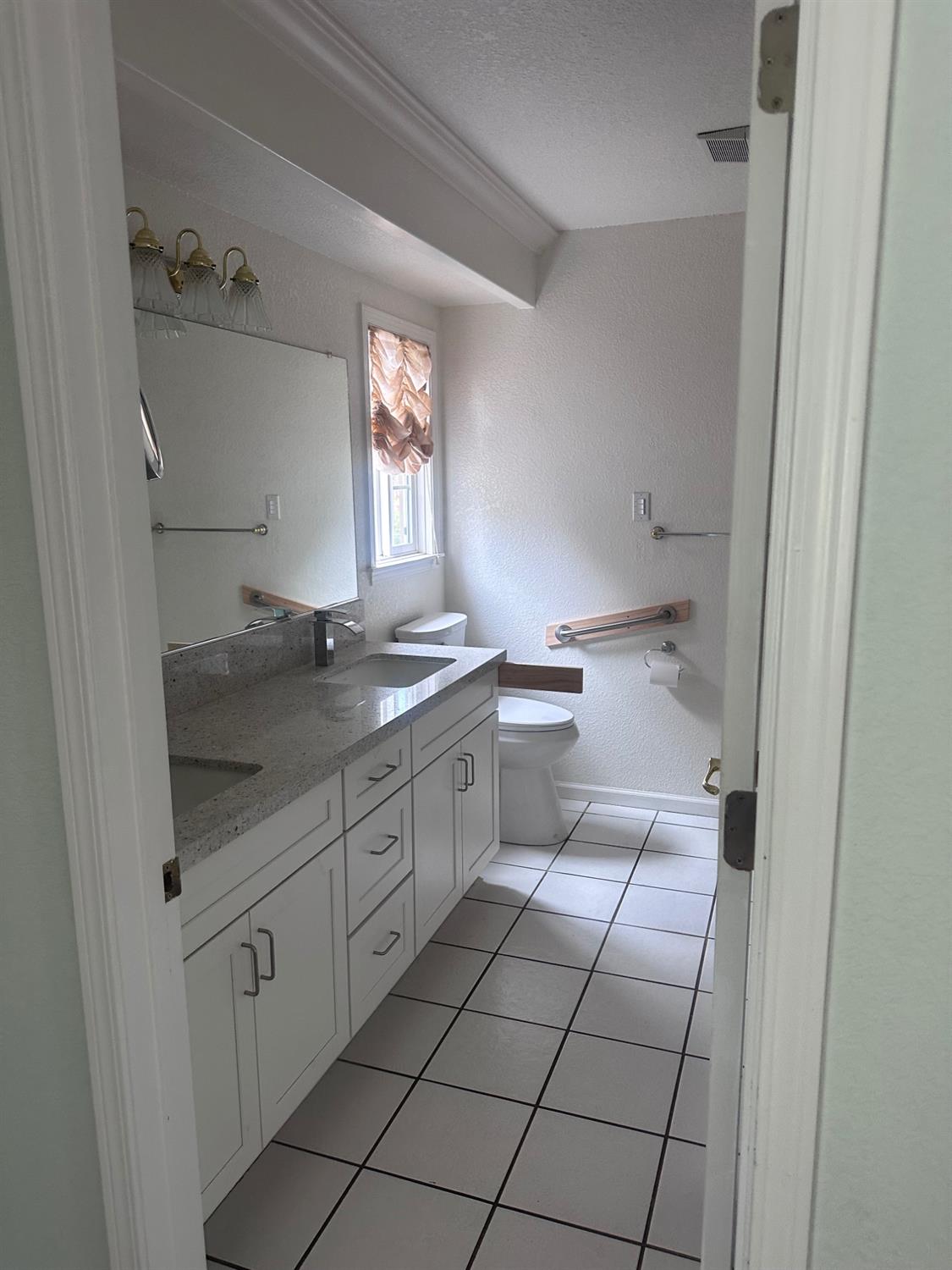 7124 Ospital Road Valley Springs, CA 95252 - Photo 21 of 37 a bathroom with a sink a toilet and a window
