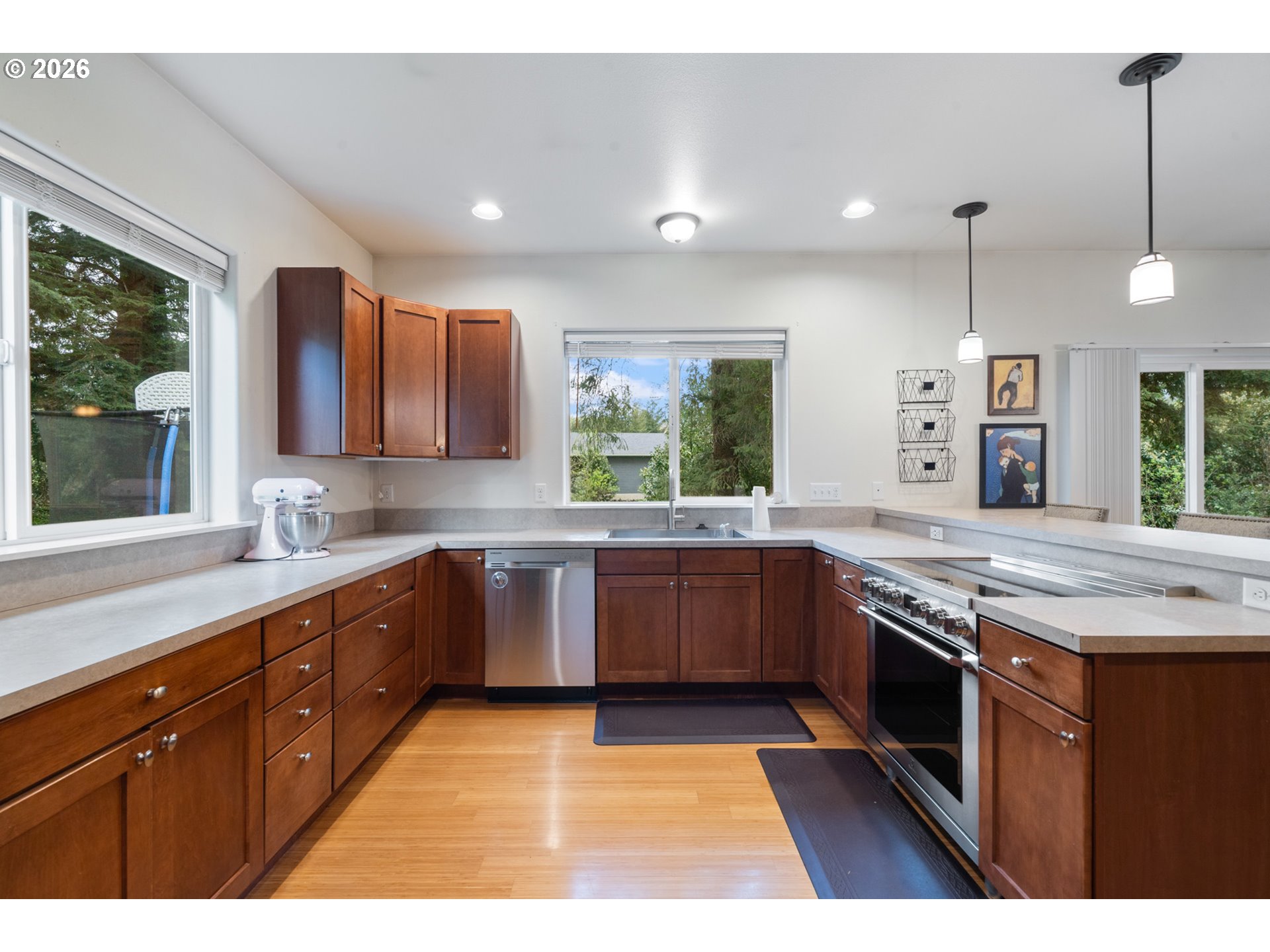 6040 Brickyard Road Tillamook, OR 97141 - Photo 12 of 41 a kitchen with stainless steel appliances granite countertop a sink a stove and a wooden cabinets