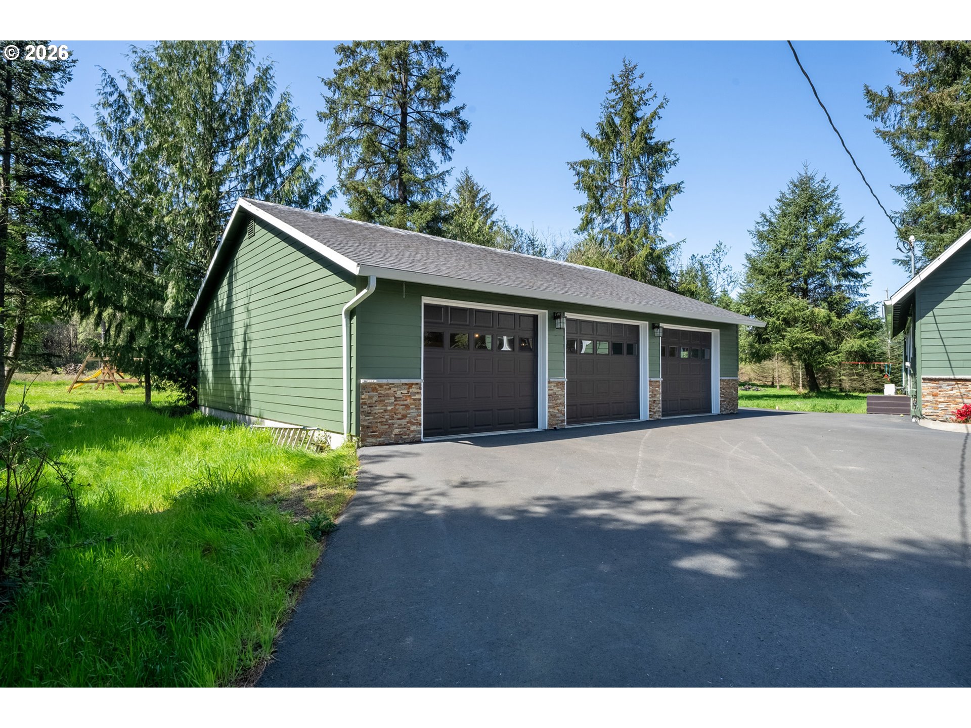 6040 Brickyard Road Tillamook, OR 97141 - Photo 30 of 41 a front view of a house with a yard and garage