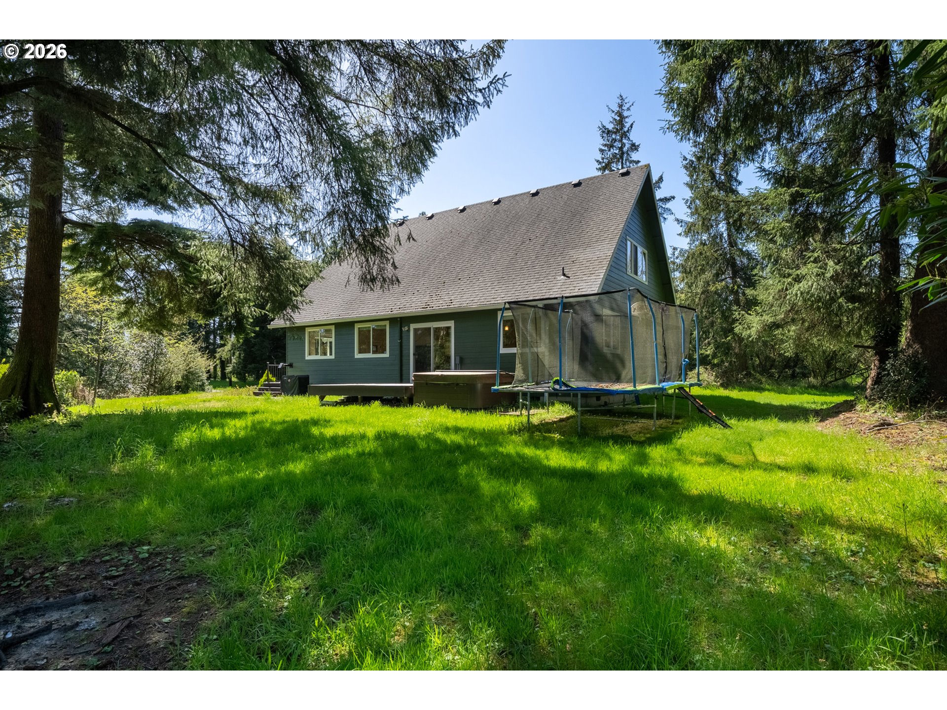 6040 Brickyard Road Tillamook, OR 97141 - Photo 35 of 41 a view of a house with a yard table and chairs