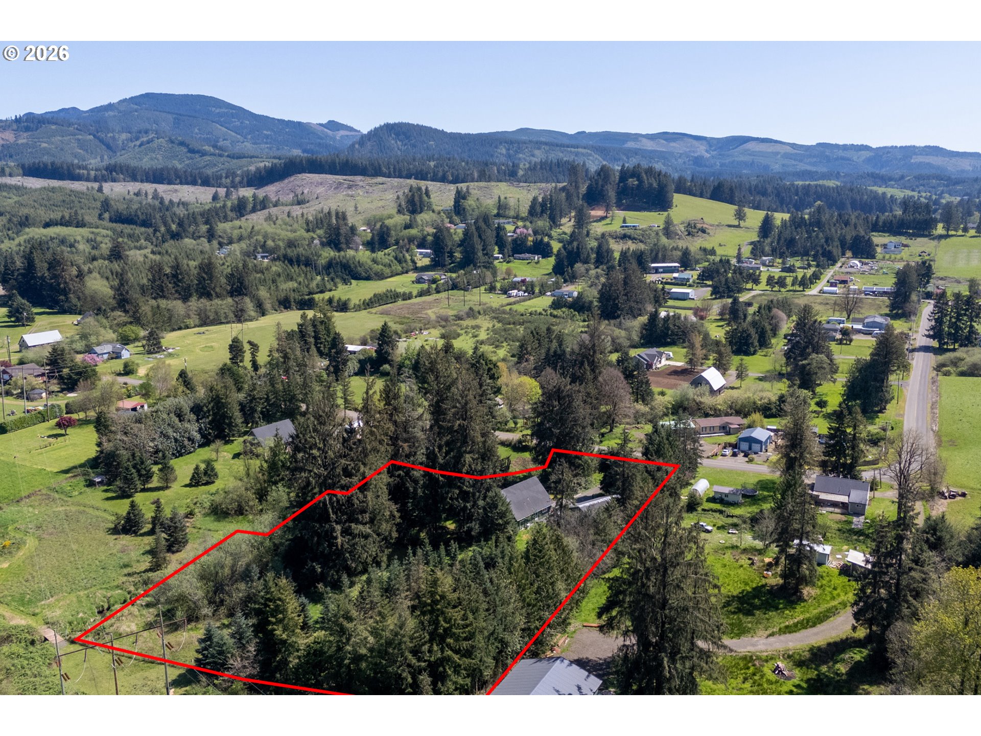 6040 Brickyard Road Tillamook, OR 97141 - Photo 38 of 41 a view of a lush green hillside and houses