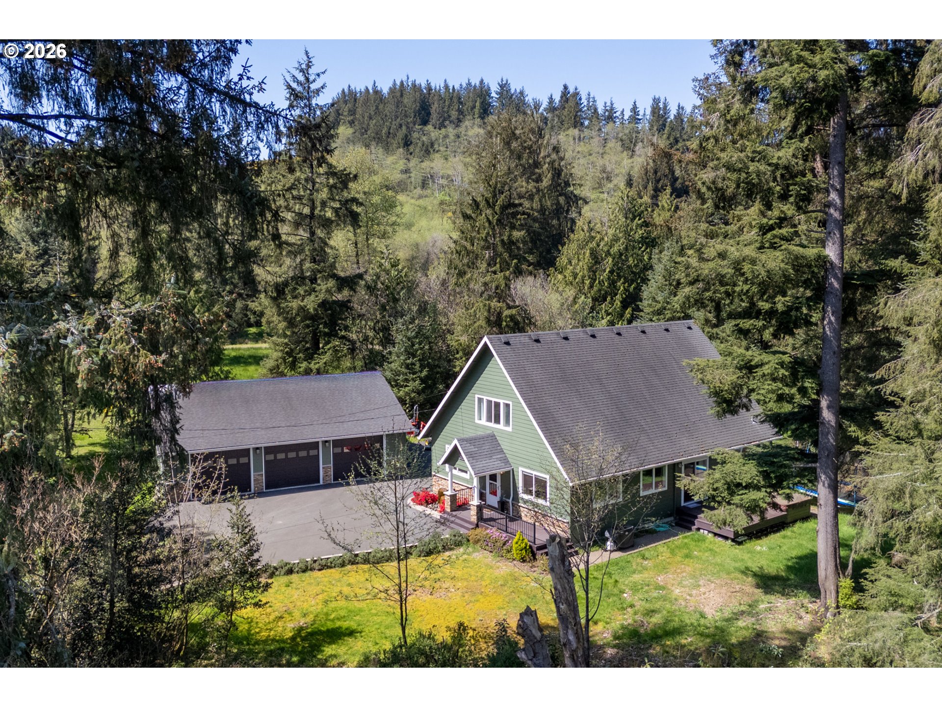 6040 Brickyard Road Tillamook, OR 97141 - Photo 40 of 41 a aerial view of a house in a big yard with plants and large trees