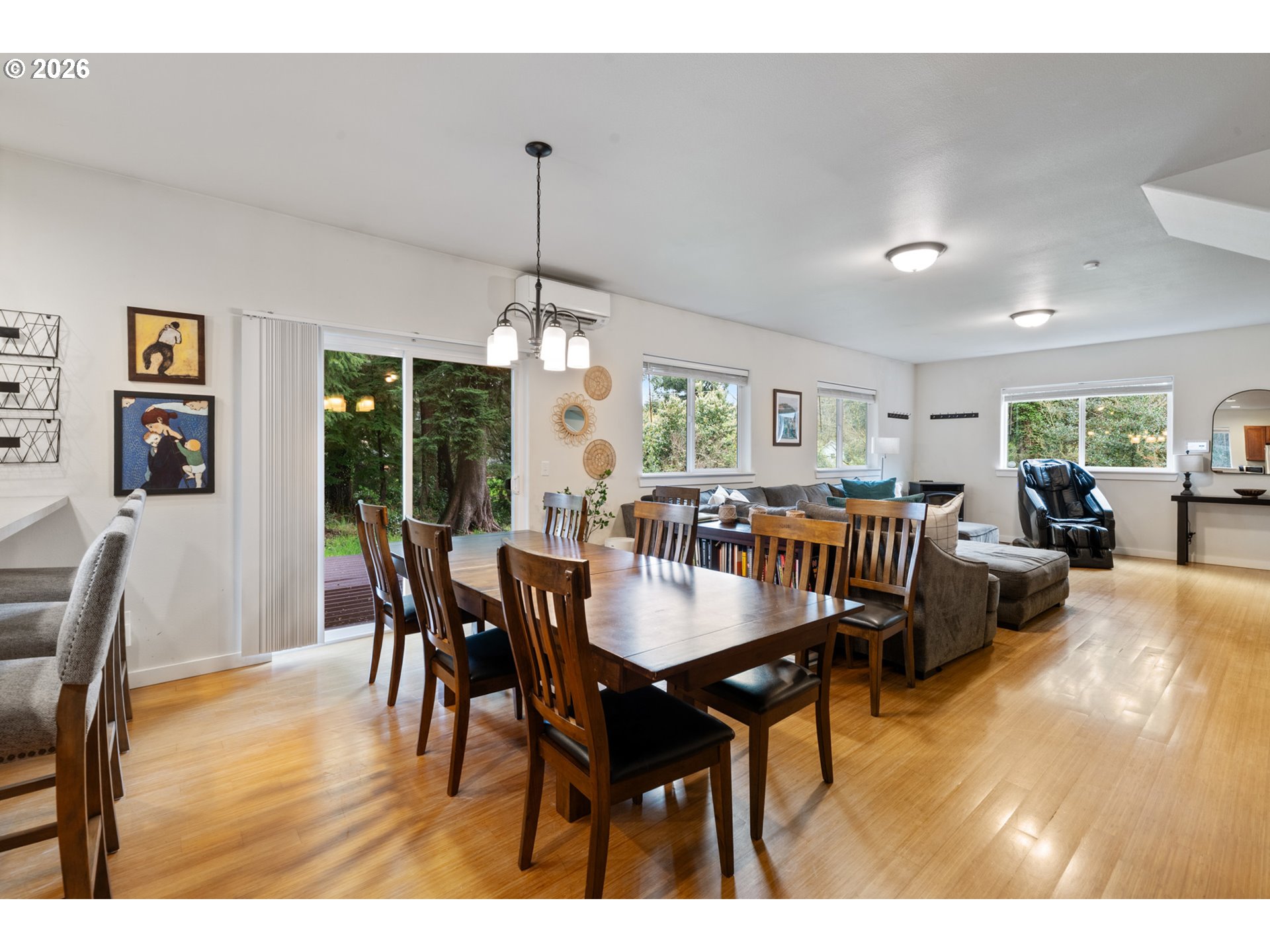 6040 Brickyard Road Tillamook, OR 97141 - Photo 10 of 41 a dining room with furniture a chandelier and wooden floor