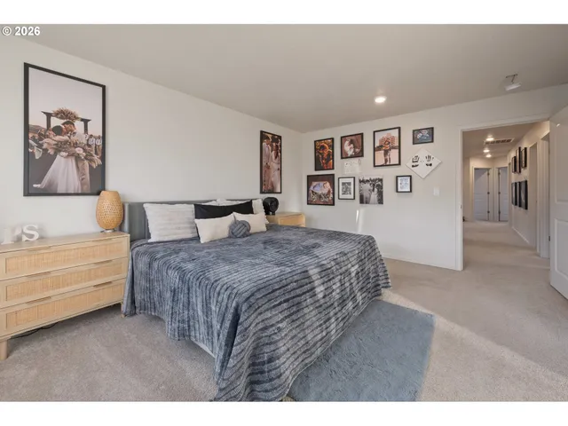 a spacious bedroom with a bed and a couch