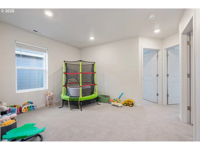 a view of an empty room and a kitchen