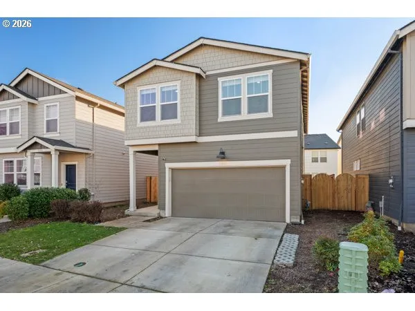 a view of backyard of house with garage