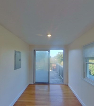272-2 Nevada Street, Unit 2 Newton, MA 02460 - Photo 8 of 28 an empty room with wooden floor and windows